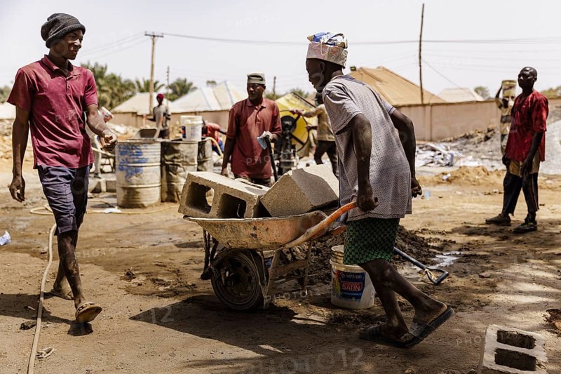 Young men working on a construction site in Nigeria, 06.02.2024