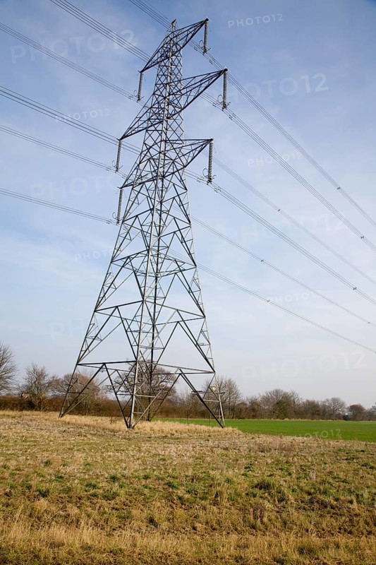 Electricity pylons crossing over countryside, Suffolk, UK