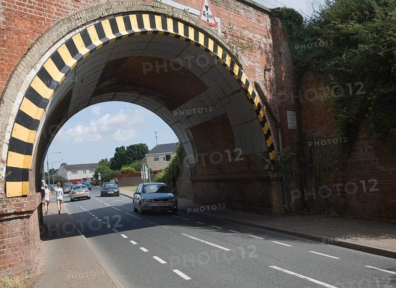 Warning paint over arch of low road bridge in Lawford, near Manningtree, Essex, England, United Kingdom, Europe