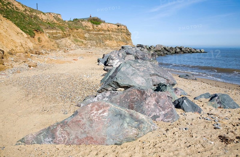 Rock armour used to defend soft crumbling cliffs, Happisburgh, Norfolk, England, United Kingdom, Europe