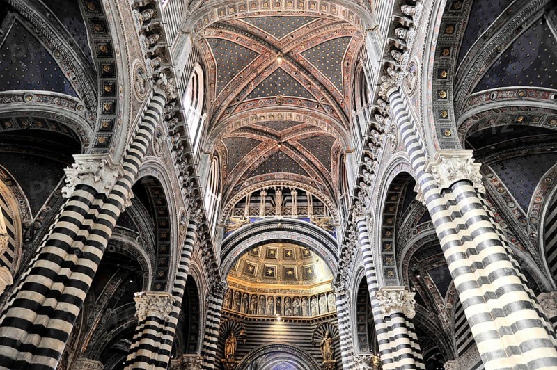 Black and white striped marble columns in the cathedral, cross and round arches, Siena, Tuscany, Italy, Europe