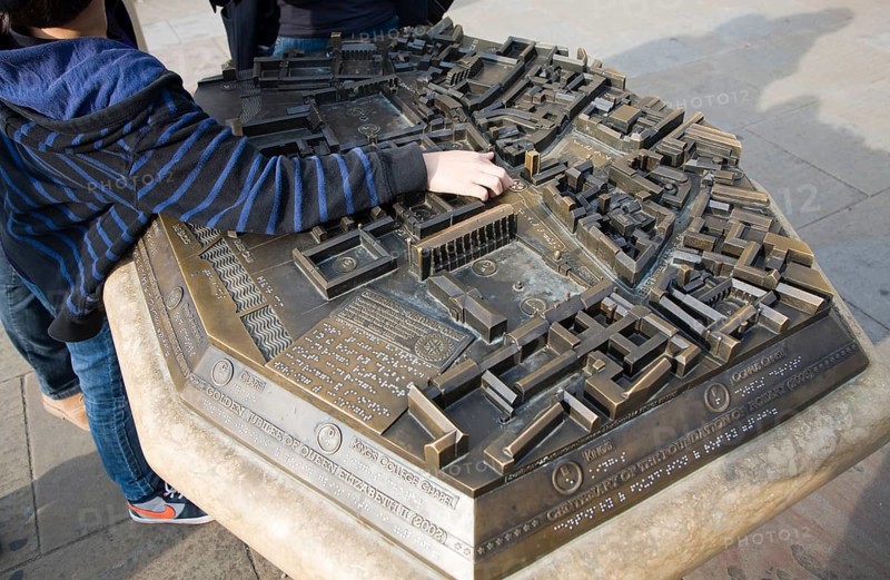 Child pointing at location on three dimensional model of the city centre, Cambridge, England, United Kingdom, Europe
