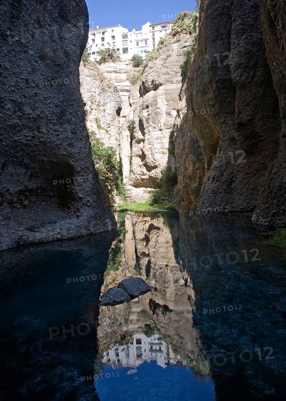 El Tajo canyon of the Rio Guadalevin river with white buildings perched on the cliff top, Ronda, Spain, Europe