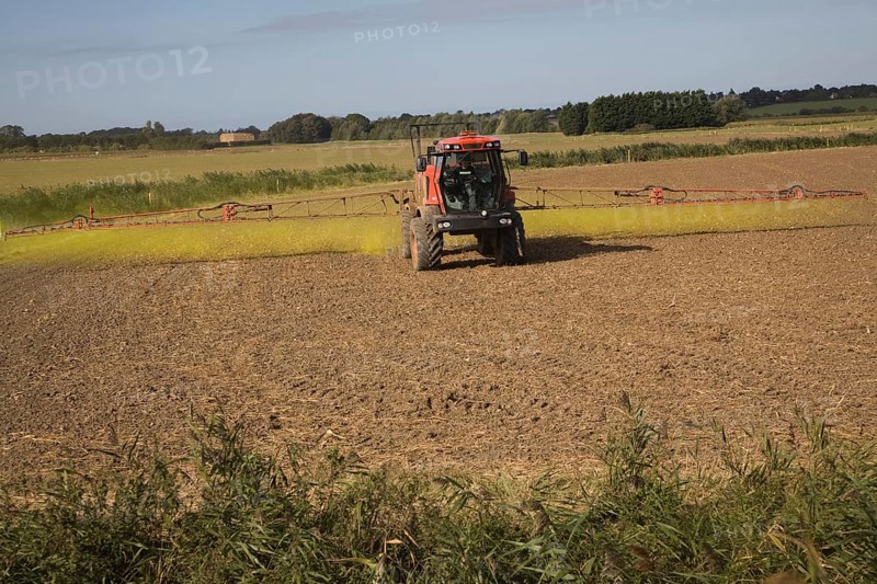 Farm machinery spraying Glyphosate herbicide on an arable field near Hollesley, Suffolk, England, United Kingdom, Europe