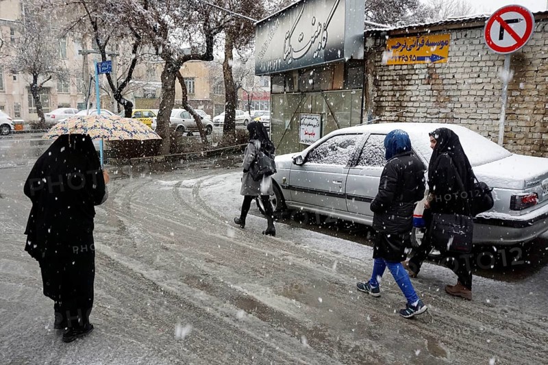 Heavy snowfall in Arak, Iran, woman with chador and umbrella and traditional clothing, 16/03/2019, Asia