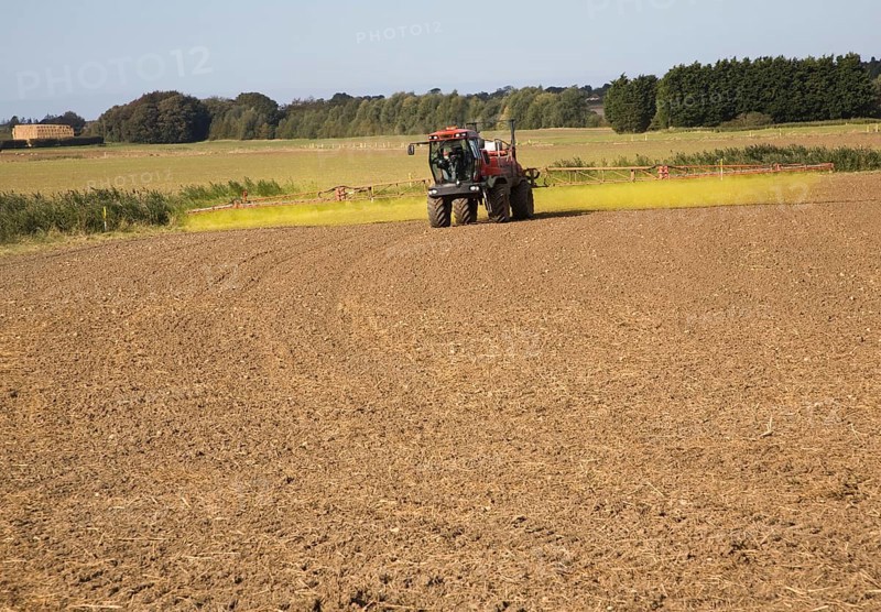 Farm machinery spraying Glyphosate herbicide on an arable field near Hollesley, Suffolk, England, United Kingdom, Europe
