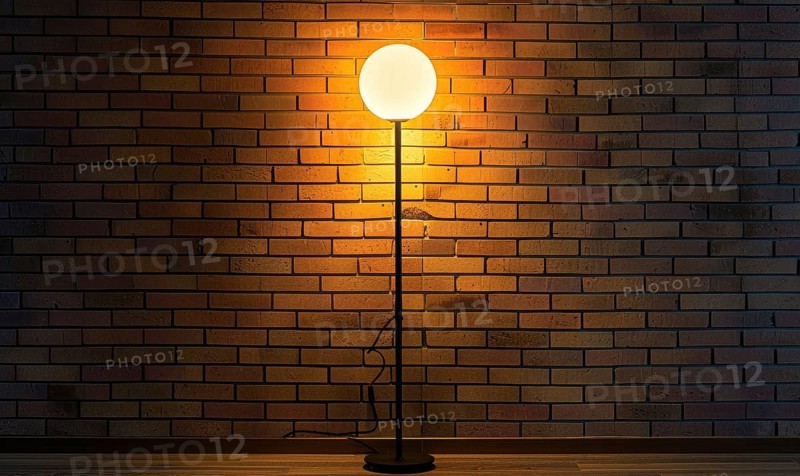 A floor lamp casting a warm glow on a brick wall, creating a cozy atmosphere AI generated