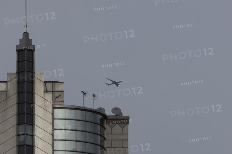 Airbus A319-100 aircraft of British airways in flight over a city skyscraper building, London, England, United Kingdom, Europe