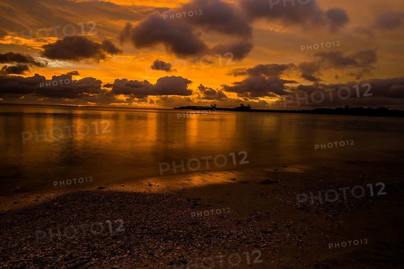 Beautiful sunset over ocean water taken from a beach in Guam
