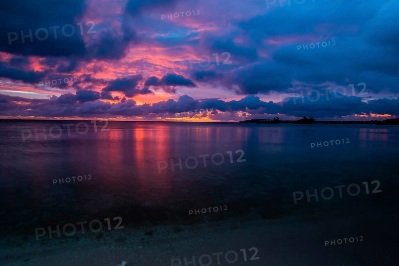 Beautiful sunset over ocean water taken from a beach in Guam