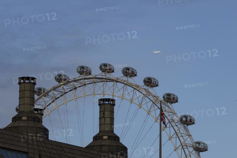 Airbus A319-100 aircraft of British airways in flight over the pods of the London Eye or Millennium Wheel, London, England, United Kingdom, Europe