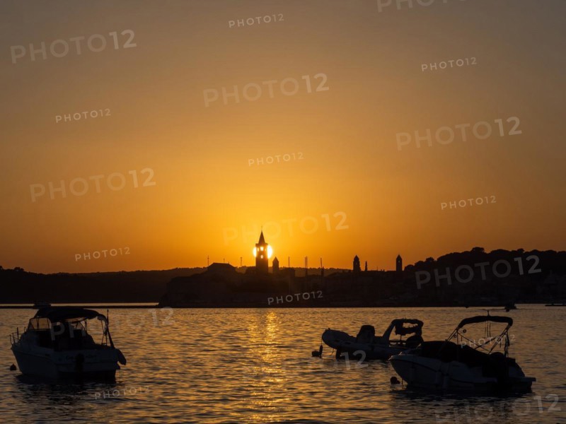 Boats anchoring in a bay, sunset, silhouette of the church towers of Rab, town of Rab, island of Rab, Kvarner Gulf Bay, Croatia, Europe