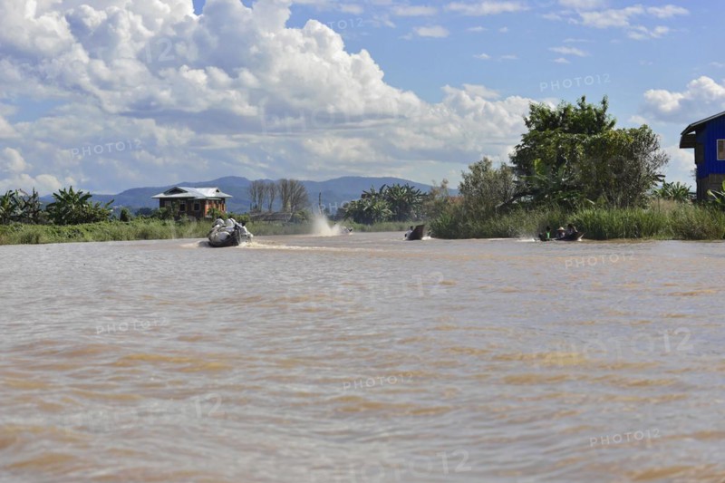 Two speedboats travelling side by side on a wide river, Inle Lake, Myanmar, Asia