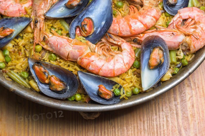 Freshly cooked seafood paella with vibrant colors served in a rustic pan, typical Spanish cuisine, Majorca, Balearic Islands, Spain, Europe