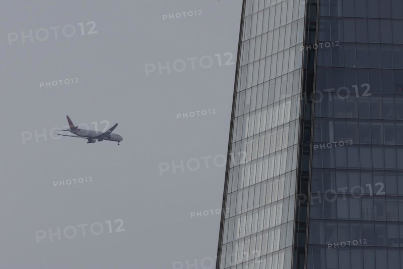 Aircraft of Air India airways in flight over The Shard city skyscraper building, London, England, United Kingdom, Europe
