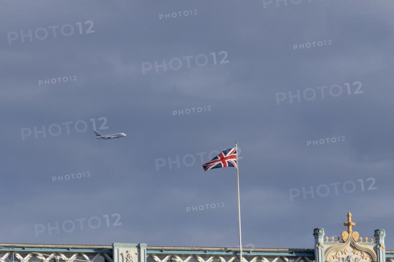 Airbus A380 aircraft of Emirates airlines in flight with a Union Jack flag on Tower Bridge in the foreground, London, England, United Kingdom, Europe