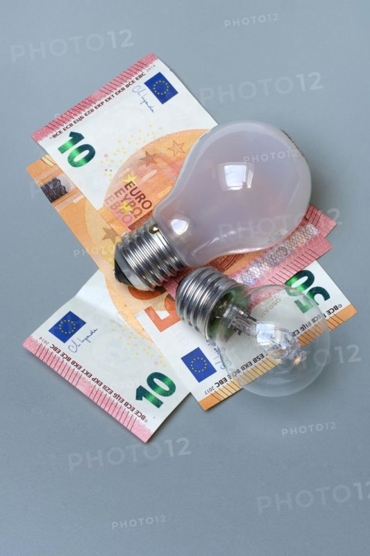 Banknotes and light bulbs, electricity costs