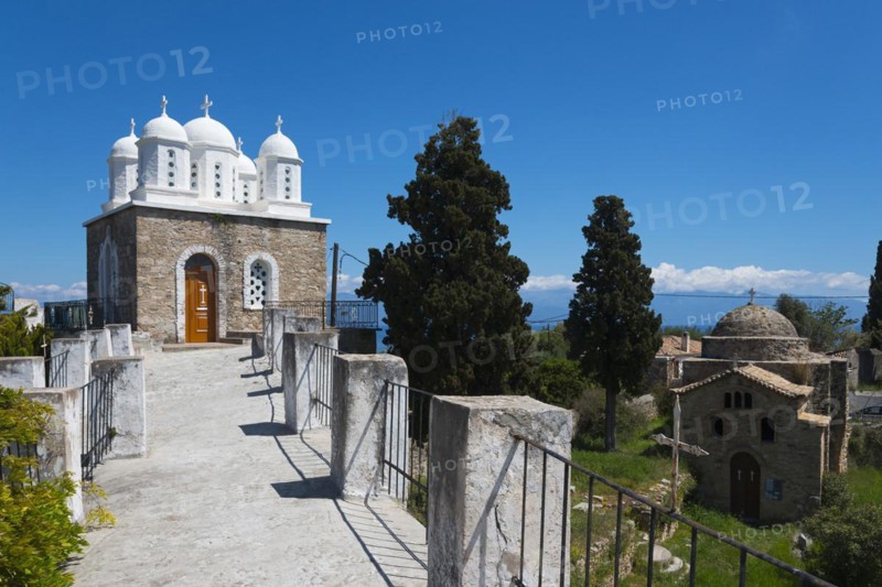Church with classical architecture, surrounded by trees and blue sky, on the right Temple of Apollo of ancient Assina, Byzantine fortress with nunnery, Holy Monastery of Timi Prodromos, Koroni, Pylos-Nestor, Messinia, Peloponnese, Greece, Europe