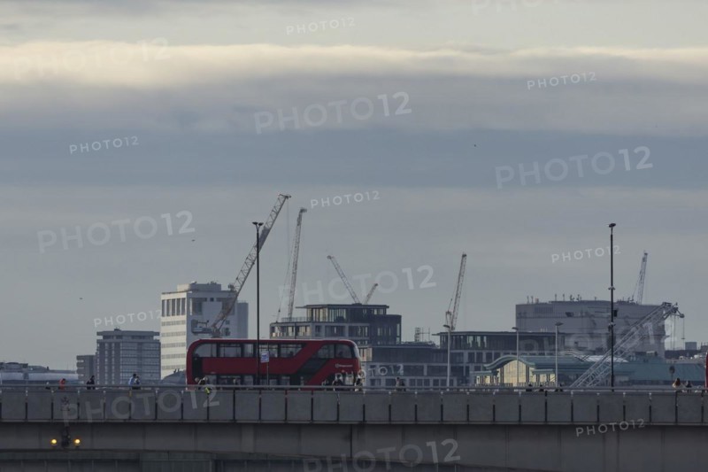 Red bus crosses over London Bridge, City of London, England, United Kingdom, Europe