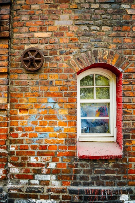 Window in brick house of Nikiszowiec, mining district of Katowice, Poland, Europe
