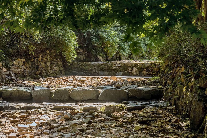 Dry rocky man made riverbed in wooded recreational forest in South Korea