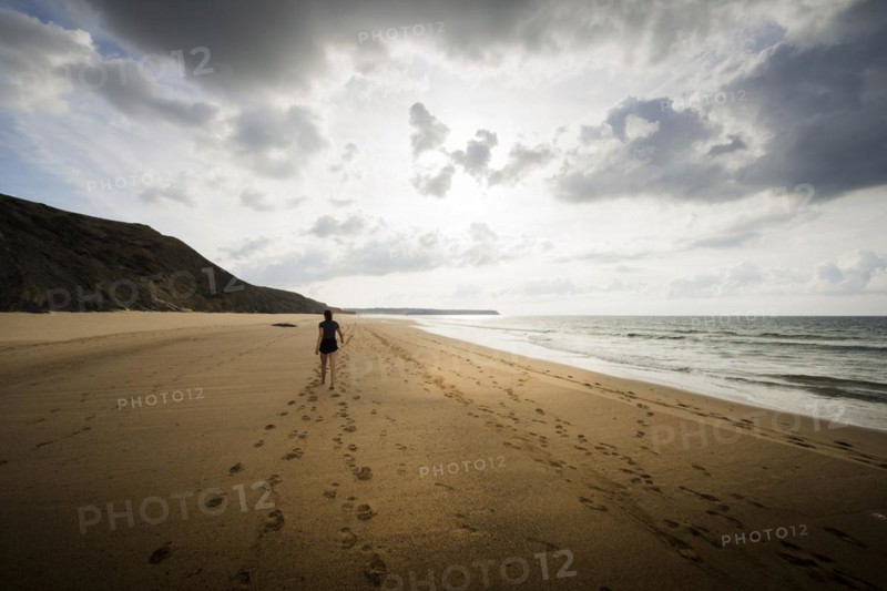 Young woman walking on the beach, emotion, rock, distance, cloudy, cloudy, mood, atmosphere, alone, lonely, empty, summer, summer holiday, holiday happiness, walk, sandy beach, tracks, footprints, active, walking, tourism, travel, symbolic, symbol, beach holiday, freedom, feeling of freedom, beach holiday, Algarve, Portugal, Europe