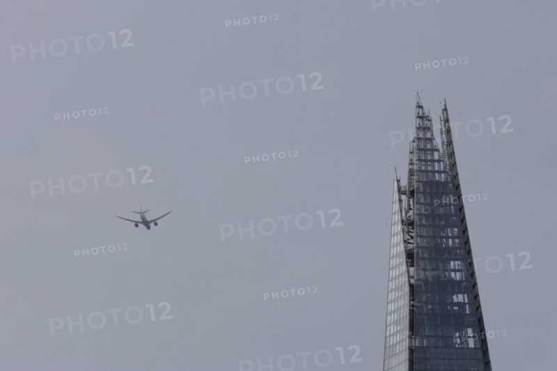 Airbus A319-100 aircraft of British airways in flight over The Shard city skyscraper building, London, England, United Kingdom, Europe