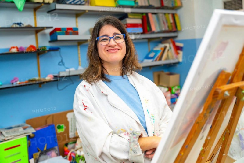 Portrait of a happy and satisfied disabled woman in the painting class
