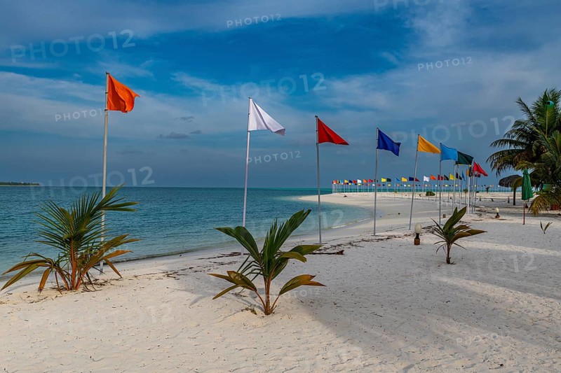 White sand beach with many flags, Bangaram island, Lakshadweep archipelago, Union territory of India