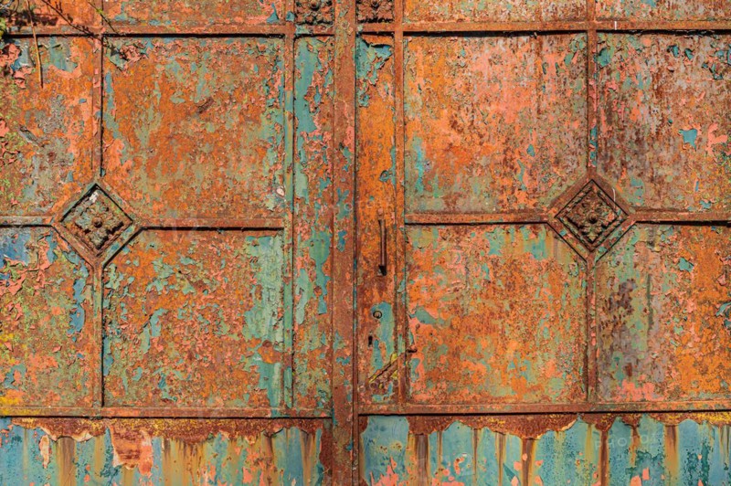 Old metallic surface with weathered rusty texture in blue-green and orange tones, Mettmann, North Rhine-Westphalia