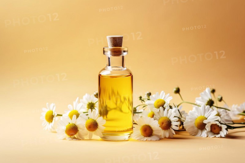Glass bottle with chamomile essential oil and flowers on yellow studio background. KI generiert, generiert AI generated