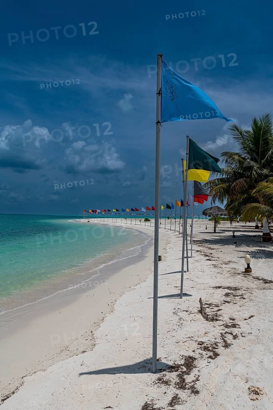 White sand beach with many flags, Bangaram island, Lakshadweep archipelago, Union territory of India