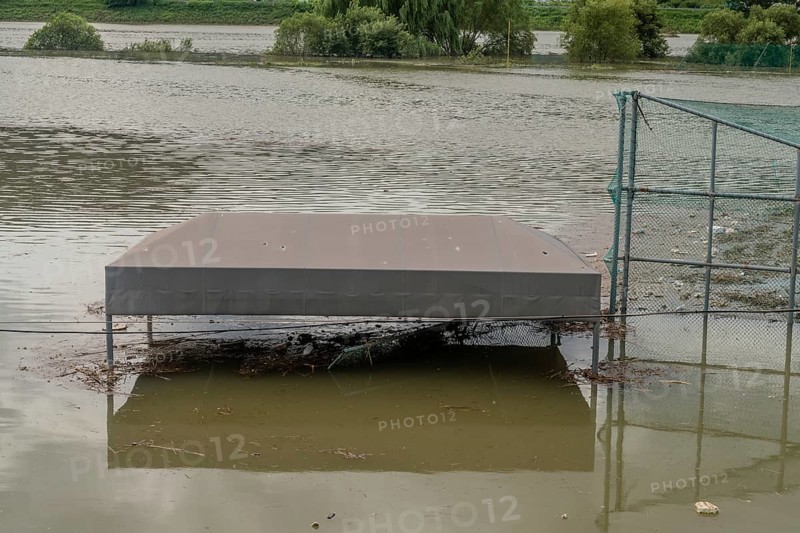Top of benches submerged by flood water at baseball diamond in riverside park after torrential monsoon rains in Daejeon South Korea