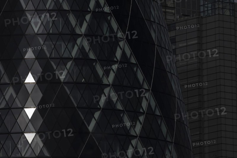 The Gherkin skyscraper building close up of window details with sunlight illuminating three triangle windows, City of London, England, United Kingdom, Europe