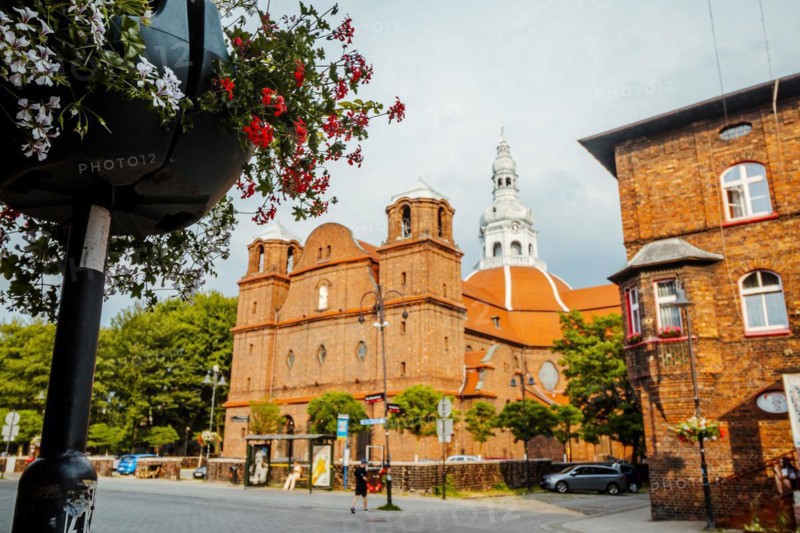 Panorama of Nikiszowiec brick architecture with flowers in the foreground in focus, Katowice, Poland, Europe