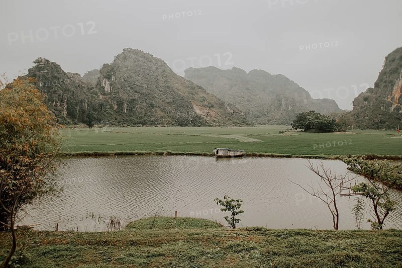 Cinematic scenery of a foggy morning in Yen Thang Lake in Ninh Binh Vietnam