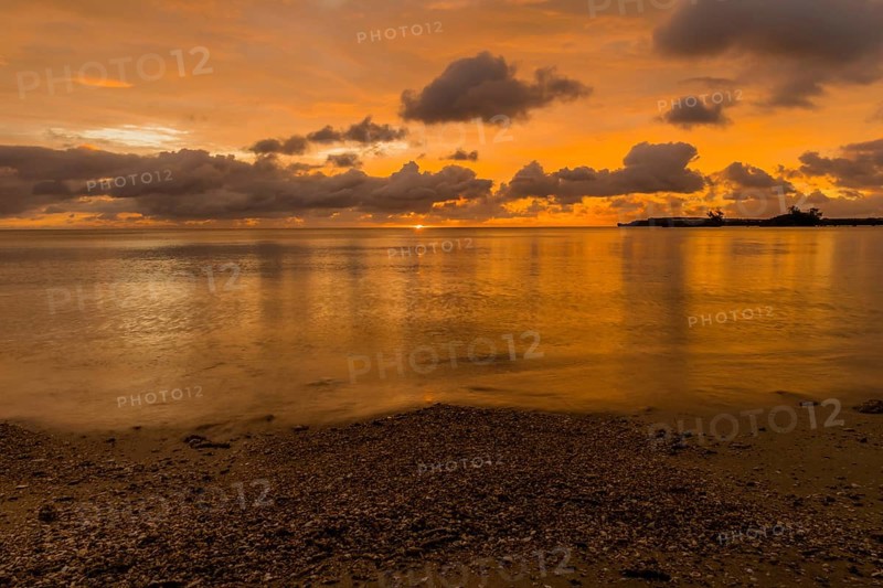 Beautiful sunset over ocean water taken from a beach in Guam