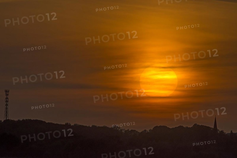 Evening sun veiled by clouds, Schoenberg, Mecklenburg-Vorpommern, Germany, Europe
