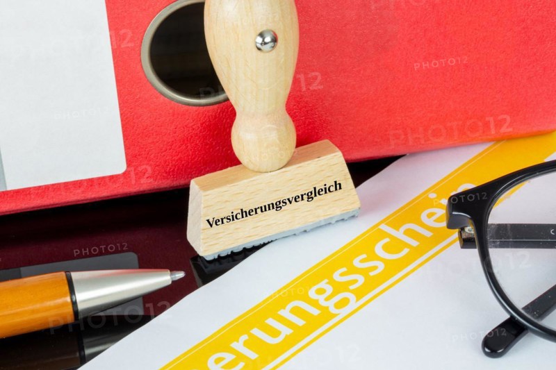 Symbolic image insurance comparison: stamp on an insurance policy