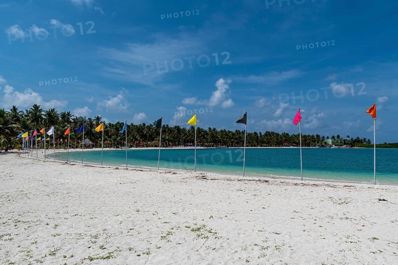 White sand beach with many flags, Bangaram island, Lakshadweep archipelago, Union territory of India