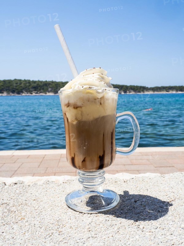Iced coffee with whipped cream, the sea in the background, Rab Island, Kvarner Gulf Bay, Croatia, Europe