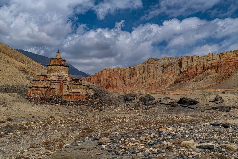 Colourfully painted Buddhist stupa, in a eroded mountain landscape, Kingdom of Mustang, Nepal, Asia