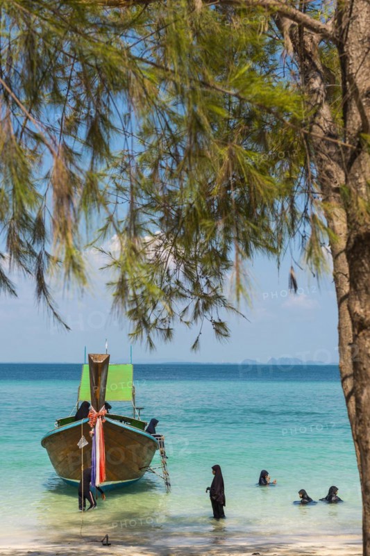 Muslim woman bathing on the beach, longtail boat, wooden boat, boat, decorated, tradition, traditional, faith, cloth, colourful, bay, sea, ocean, Andaman Sea, tropics, tropical, island, water, beach, beach holiday, Caribbean, environment, clear, clear, clean, peaceful, picturesque, climate, travel, tourism, paradisiacal, beach holiday, sun, sunny, holiday, paradise, coastal landscape, nature, idyllic, turquoise, Siam, exotic, travel photo, sandy beach, seascape, Phi Phi Island, Thailand, Asia