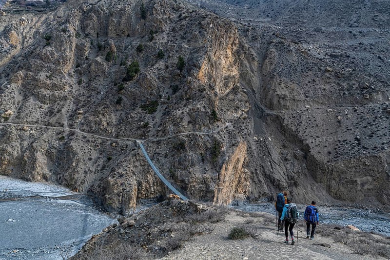 Tourists hiking a huge hanging bridge, Kingdom of Mustang, Nepal, Asia