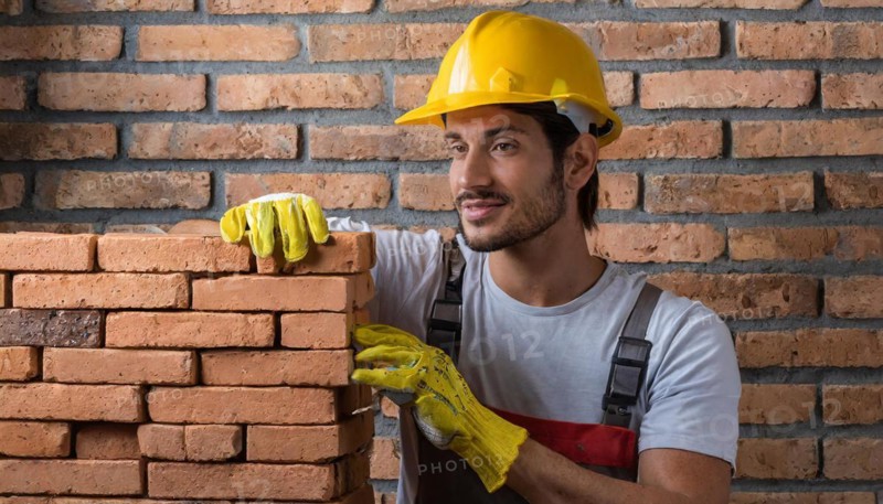 AI generated, A bricklayer inspects a brick wall, 30, 35, years