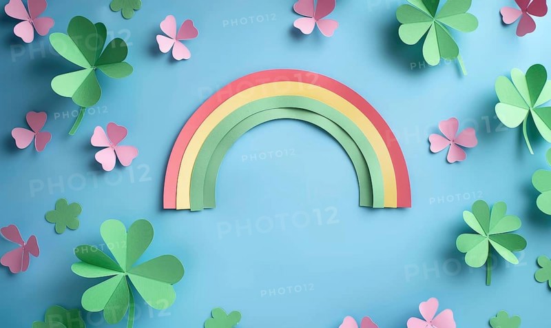 Simple yet attractive paper cutouts of a rainbow and shamrocks on blue AI generated