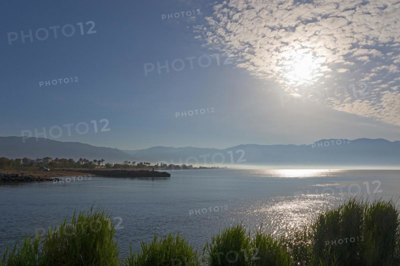 A peaceful sunrise over a coastal landscape with clouds in the sky and calm sea, mouth of the river Pamisos, Messini, Messinia, Peloponnese, Greece Motorhome drives over a bridge, Bouka Beach, Messini, Messinia, Peloponnese, Greece, Europe