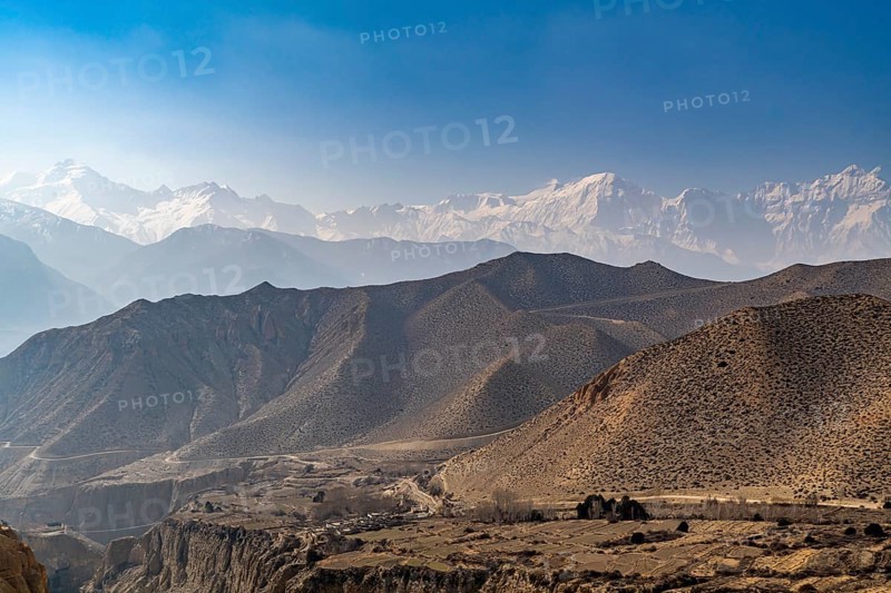 Desert mountain scenery with the Annapurna mountain range in the background, Kingdom of Mustang, Nepal, Asia