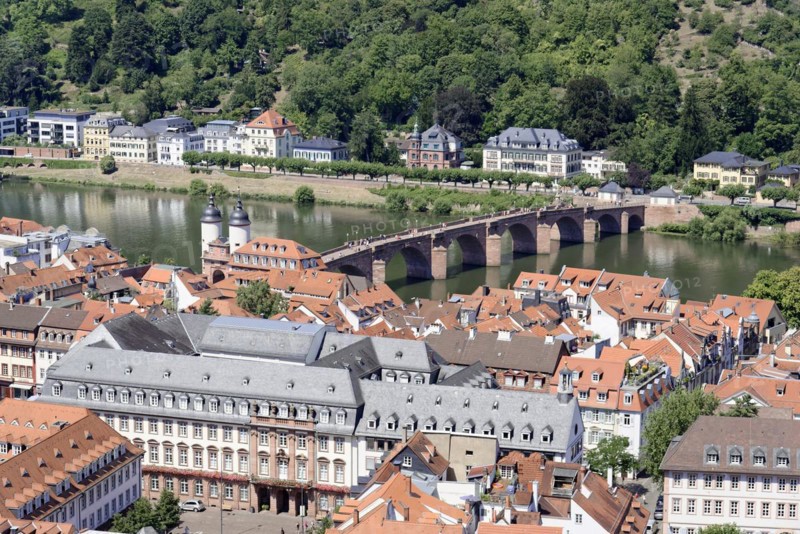 Historic stone bridge over a river (Neckar), with neighbouring riverside houses, Heidelberg, Baden-Wuerttemberg, Germany, Europe