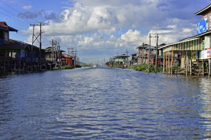 Village on stilts along a quiet waterway, Inle Lake, Myanmar, Asia